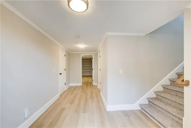 a view of a room with wooden floor and stairs