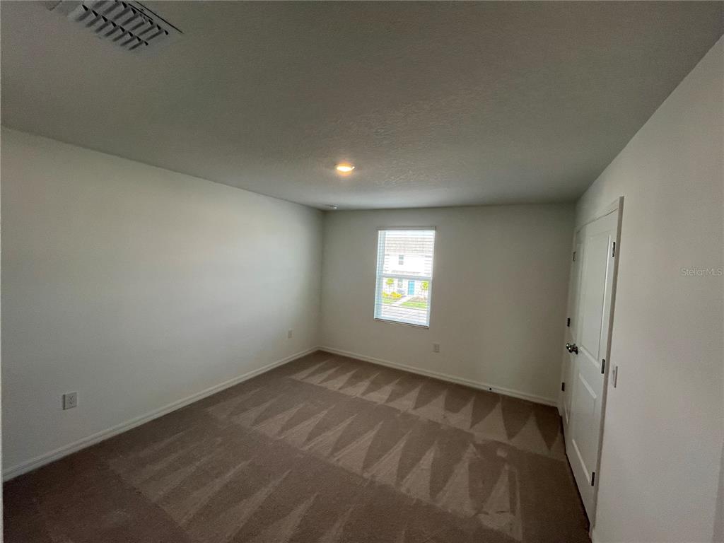 2995 Skyline Loop Kissimmee, FL 34758 - Photo 20 of 46 an empty room with a window