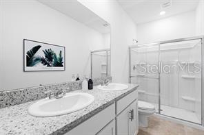 2995 Skyline Loop Kissimmee, FL 34758 - Photo 25 of 46 a bathroom with 2 sink and a mirror