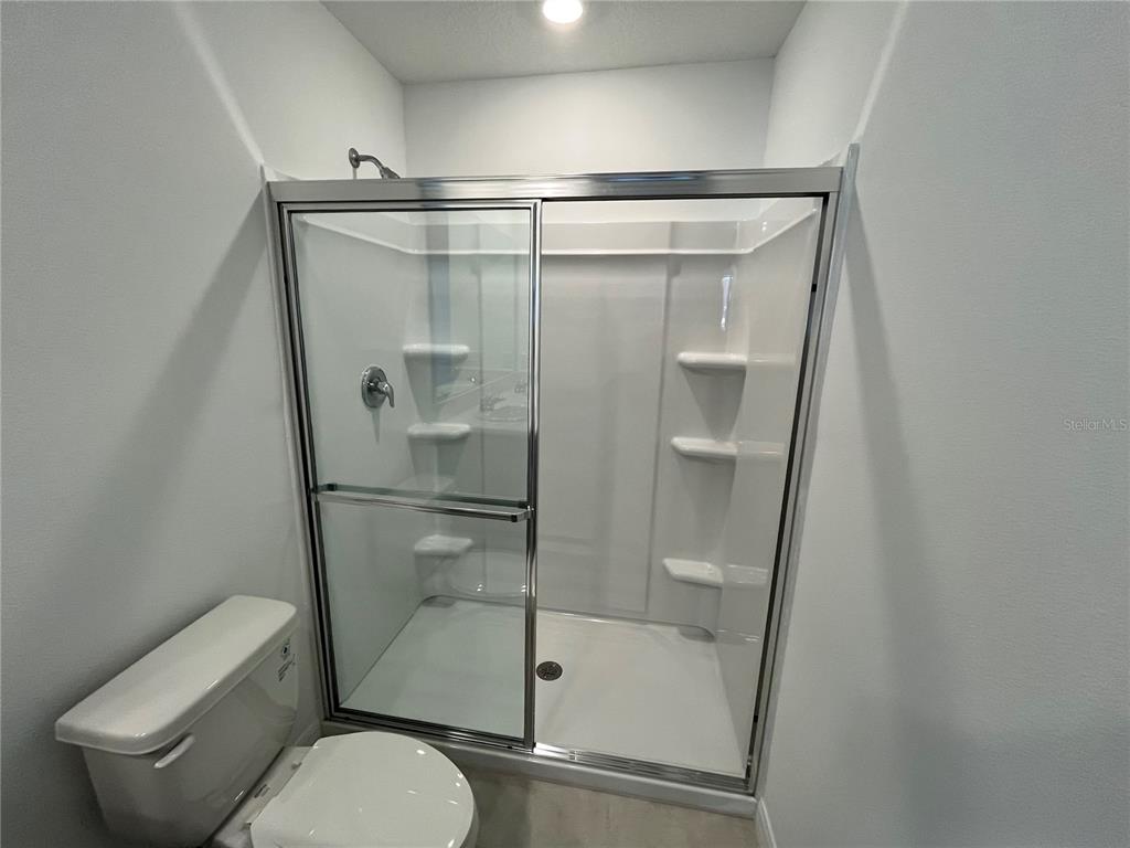 2995 Skyline Loop Kissimmee, FL 34758 - Photo 26 of 46 a bathroom with a shower a toilet and sink