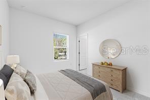 2995 Skyline Loop Kissimmee, FL 34758 - Photo 29 of 46 a bedroom with a bed a chandelier and a window