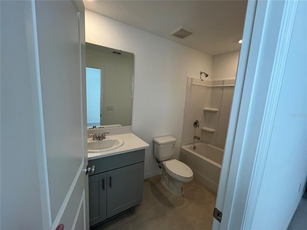 2995 Skyline Loop Kissimmee, FL 34758 - Photo 32 of 46 a bathroom with a toilet sink and mirror