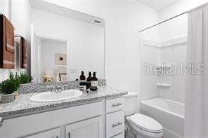 2995 Skyline Loop Kissimmee, FL 34758 - Photo 35 of 46 a bathroom with a granite countertop sink a toilet and bathtub