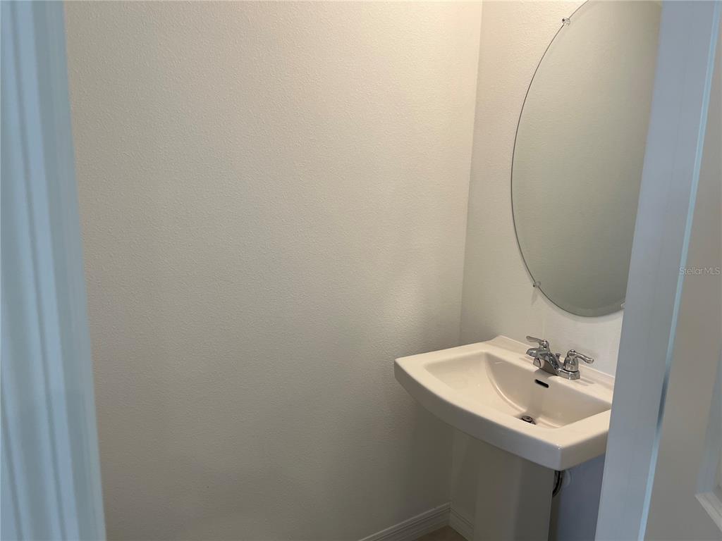 2995 Skyline Loop Kissimmee, FL 34758 - Photo 9 of 46 a bathroom with a sink and a mirror