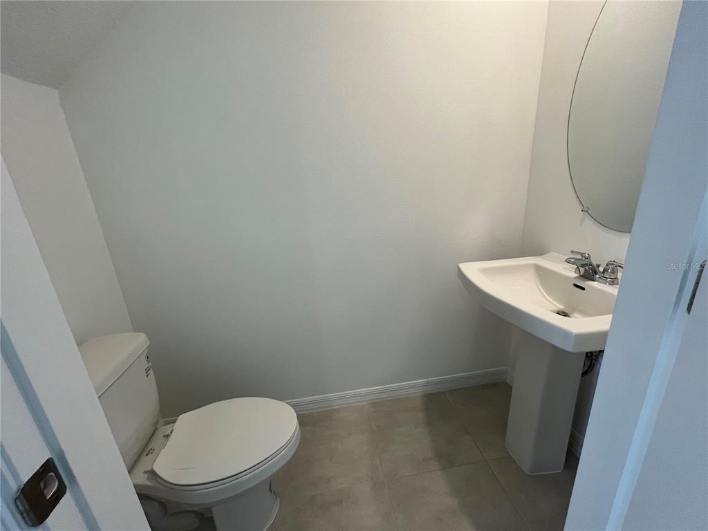 2995 Skyline Loop Kissimmee, FL 34758 - Photo 10 of 46 a bathroom with a sink toilet and mirror