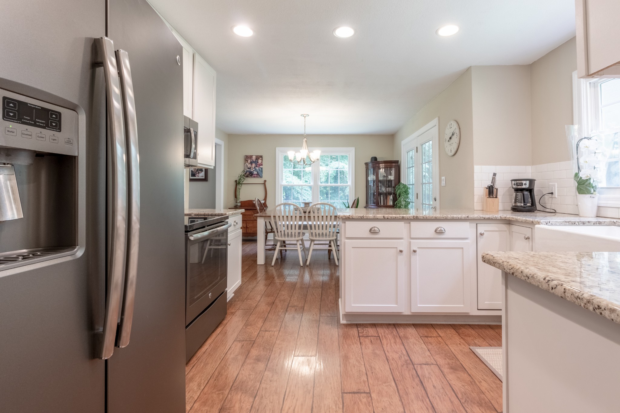 491 Harper Road Clarksville, TN 37043 - Photo 11 of 33 a kitchen with stainless steel appliances granite countertop a refrigerator a sink dishwasher a stove and white countertops with wooden floor