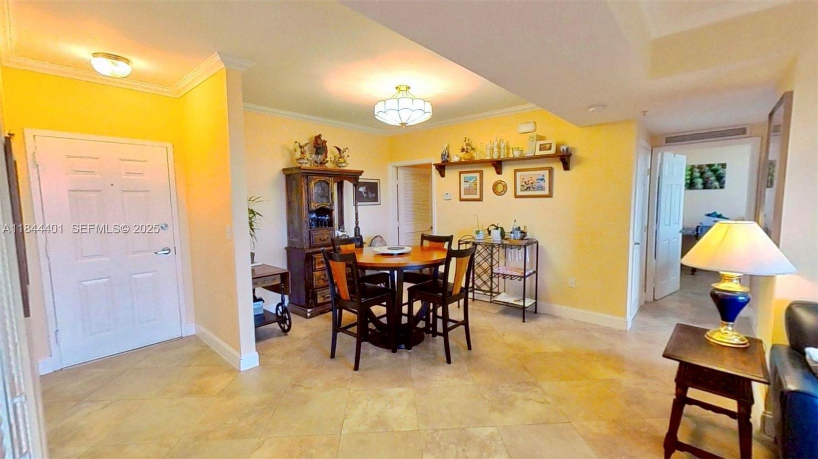 2425 Southwest 27th Avenue, Unit 701 Miami, FL 33145 - Photo 11 of 57 a view of a dining room with furniture and a chandelier
