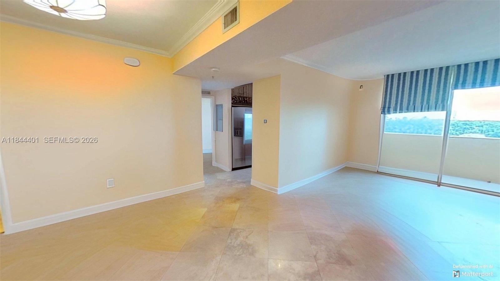 2425 Southwest 27th Avenue, Unit 701 Miami, FL 33145 - Photo 14 of 49 De-Furnished View of Living Area, Kitchen Entry, Door to 2nd Bedroom