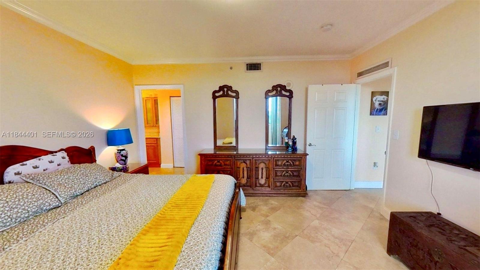 2425 Southwest 27th Avenue, Unit 701 Miami, FL 33145 - Photo 16 of 49 a bedroom with a bed and flat screen tv