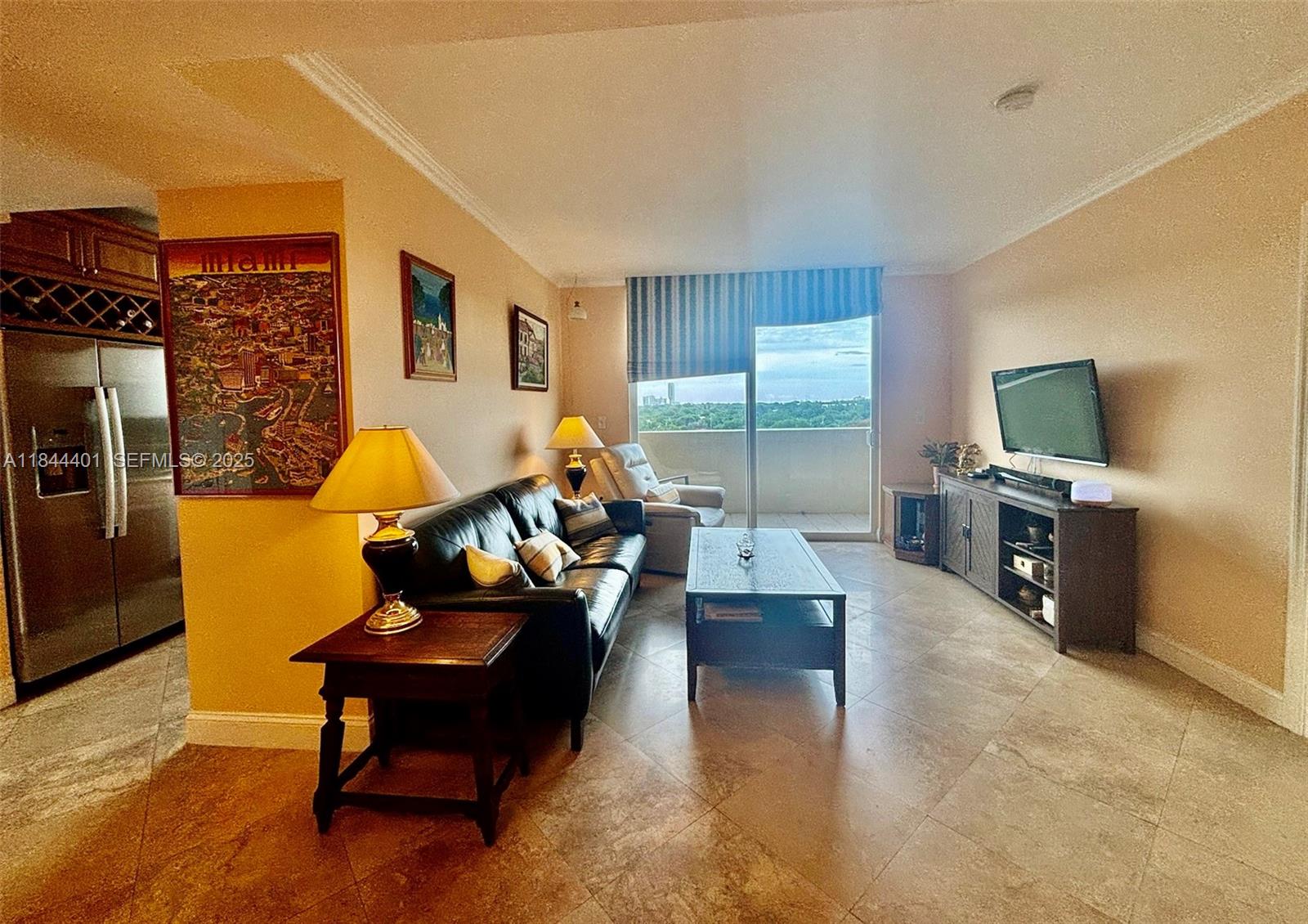 2425 Southwest 27th Avenue, Unit 701 Miami, FL 33145 - Photo 16 of 57 a living room with furniture and a flat screen tv