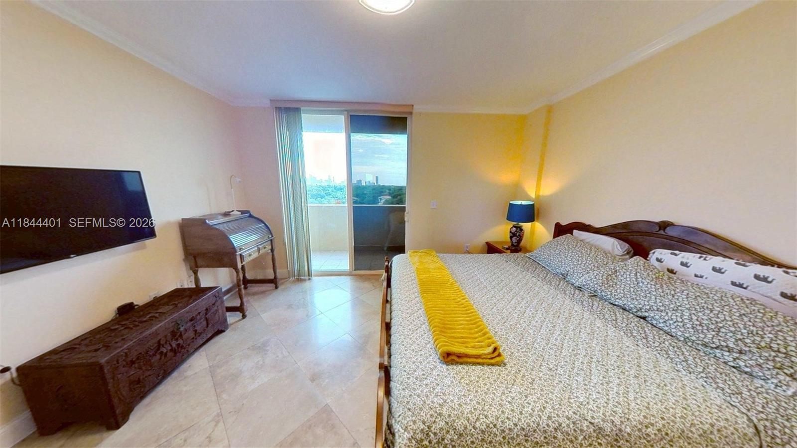 2425 Southwest 27th Avenue, Unit 701 Miami, FL 33145 - Photo 17 of 49 a bed room with a bed and a chair