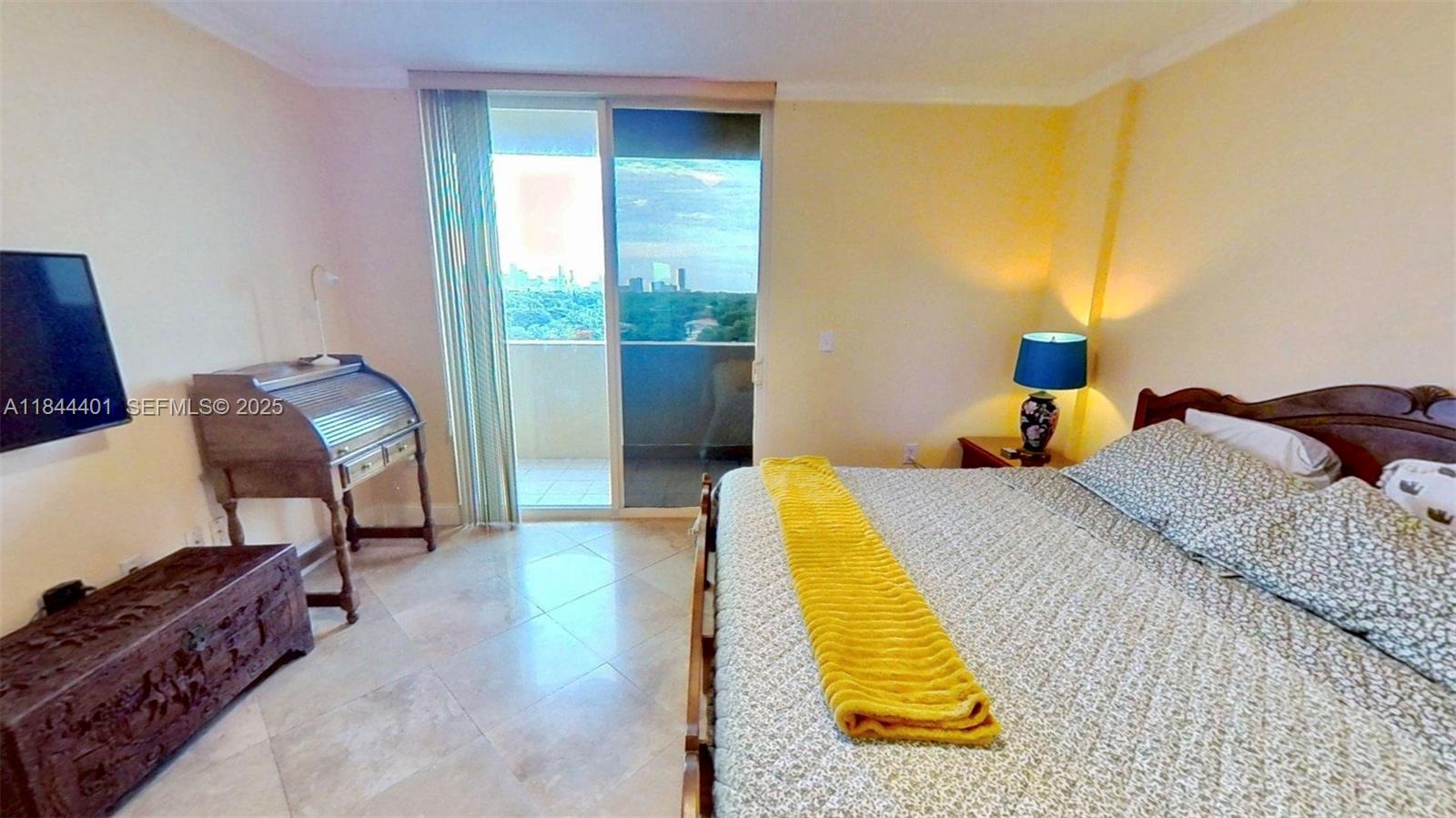 2425 Southwest 27th Avenue, Unit 701 Miami, FL 33145 - Photo 19 of 57 a bed sitting in a bedroom next to a window