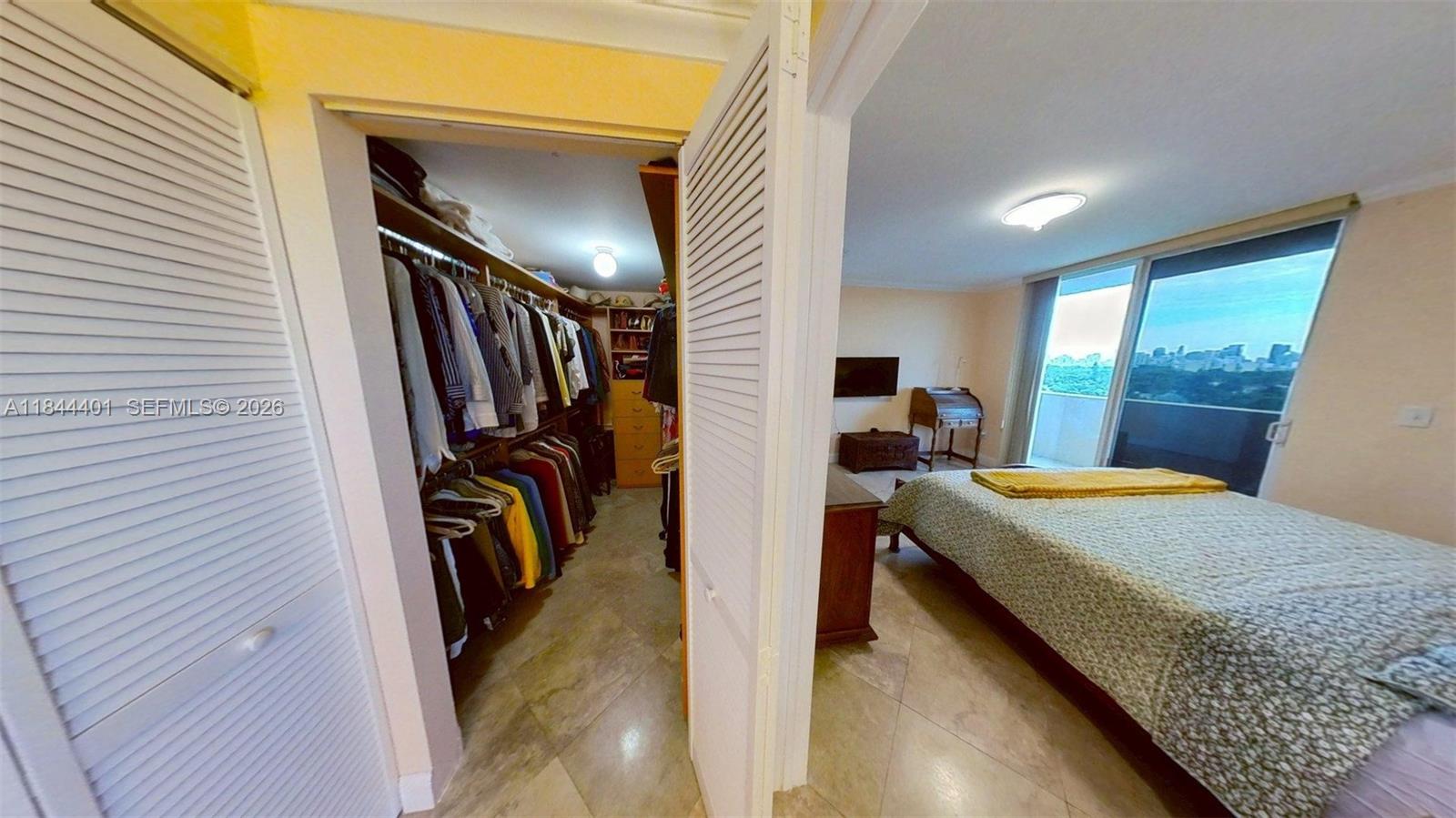 2425 Southwest 27th Avenue, Unit 701 Miami, FL 33145 - Photo 19 of 49 Primary Bedroom and Large Walk-In Closet
