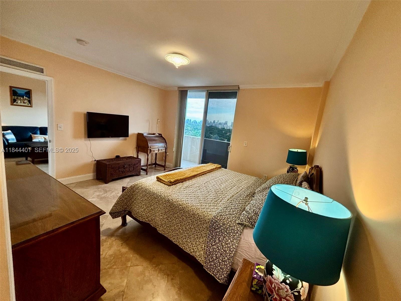 2425 Southwest 27th Avenue, Unit 701 Miami, FL 33145 - Photo 20 of 57 a bedroom with a bed and window