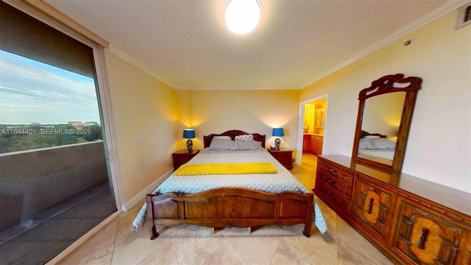 2425 Southwest 27th Avenue, Unit 701 Miami, FL 33145 - Photo 2 of 49 Primary Bedroom - Balcony Access With King-Size Bed