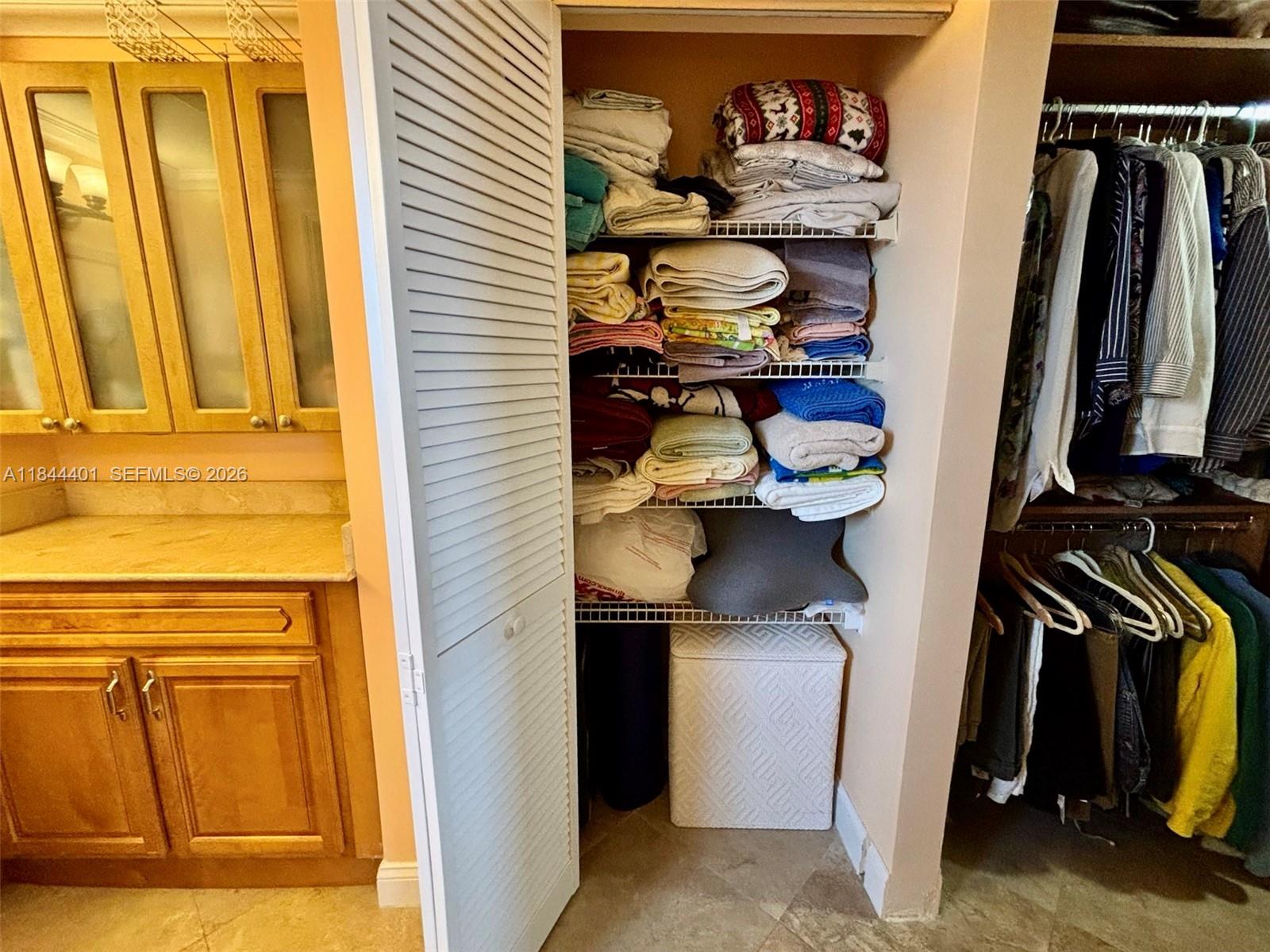2425 Southwest 27th Avenue, Unit 701 Miami, FL 33145 - Photo 21 of 49 a view of walk in closet with clothes and shoes