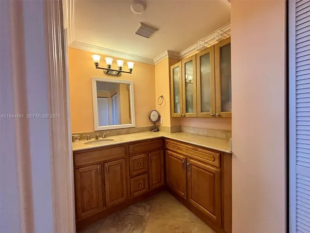 a bedroom with a bed and a large mirror