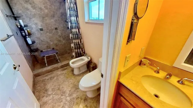 a bedroom with a bed a mirror and dresser