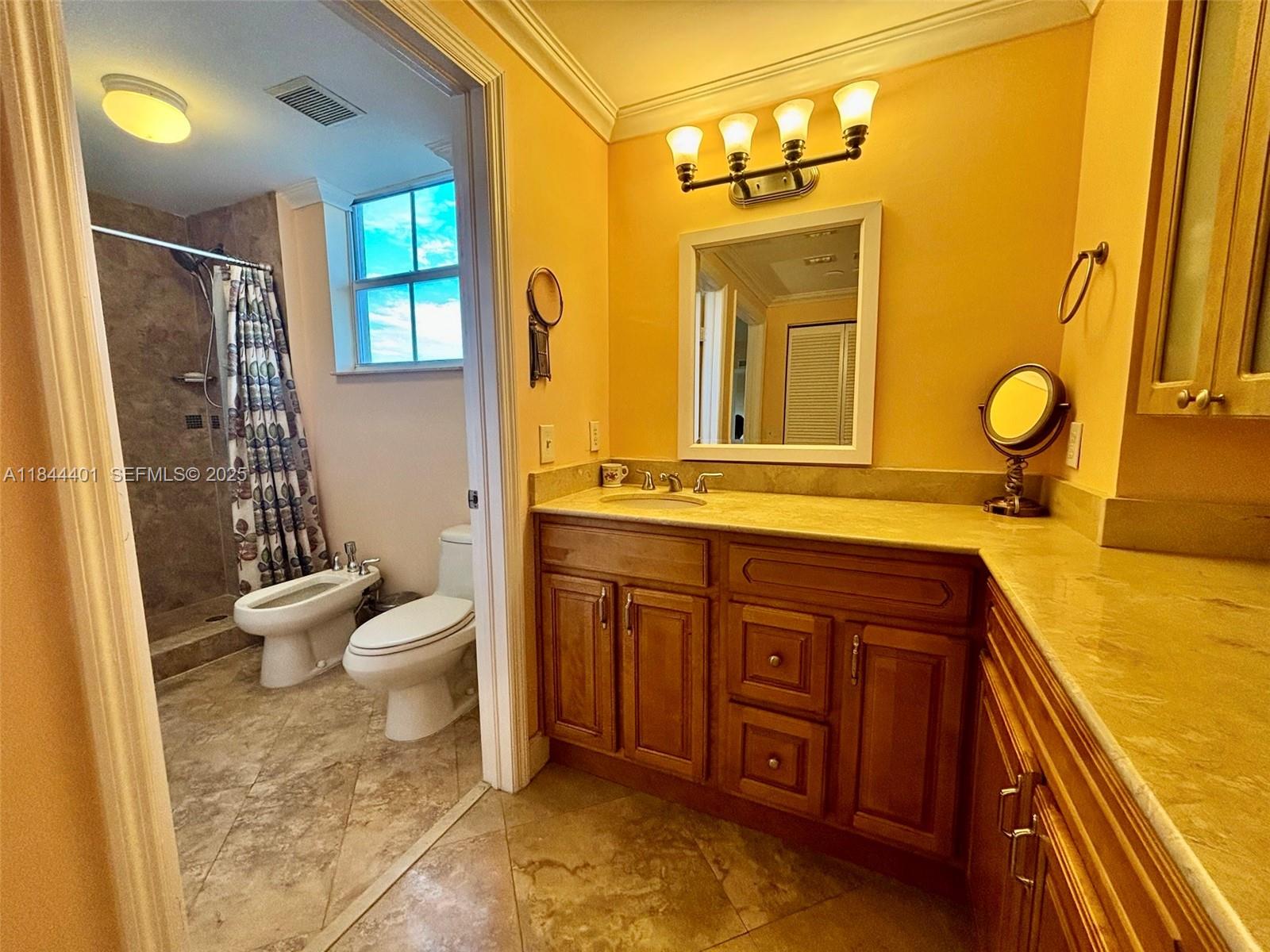 2425 Southwest 27th Avenue, Unit 701 Miami, FL 33145 - Photo 29 of 57 Primary Bathroom and Vanity