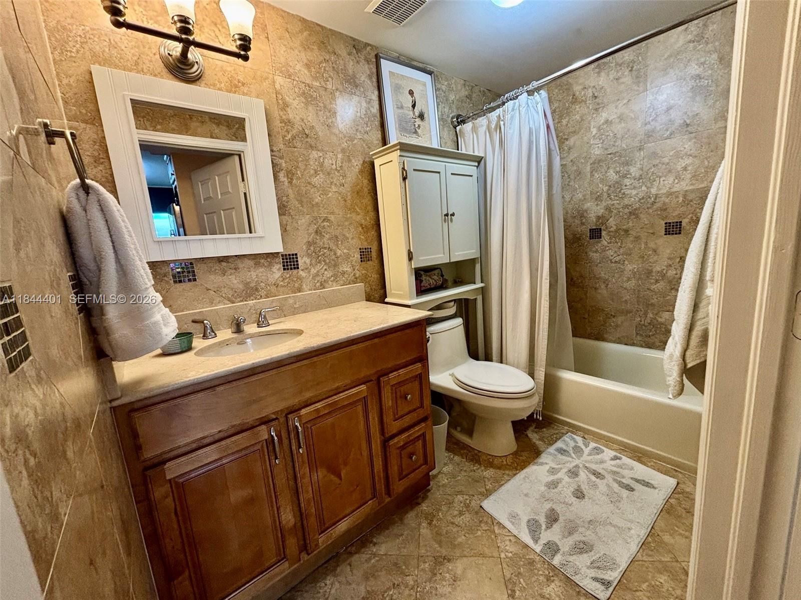 2425 Southwest 27th Avenue, Unit 701 Miami, FL 33145 - Photo 36 of 49 a bathroom with a sink toilet and shower