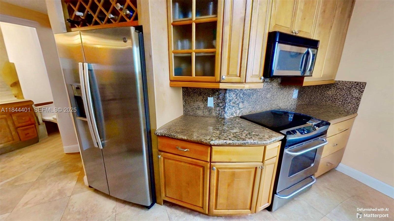 2425 Southwest 27th Avenue, Unit 701 Miami, FL 33145 - Photo 36 of 57 a kitchen with stainless steel appliances granite countertop a stove a refrigerator and a sink