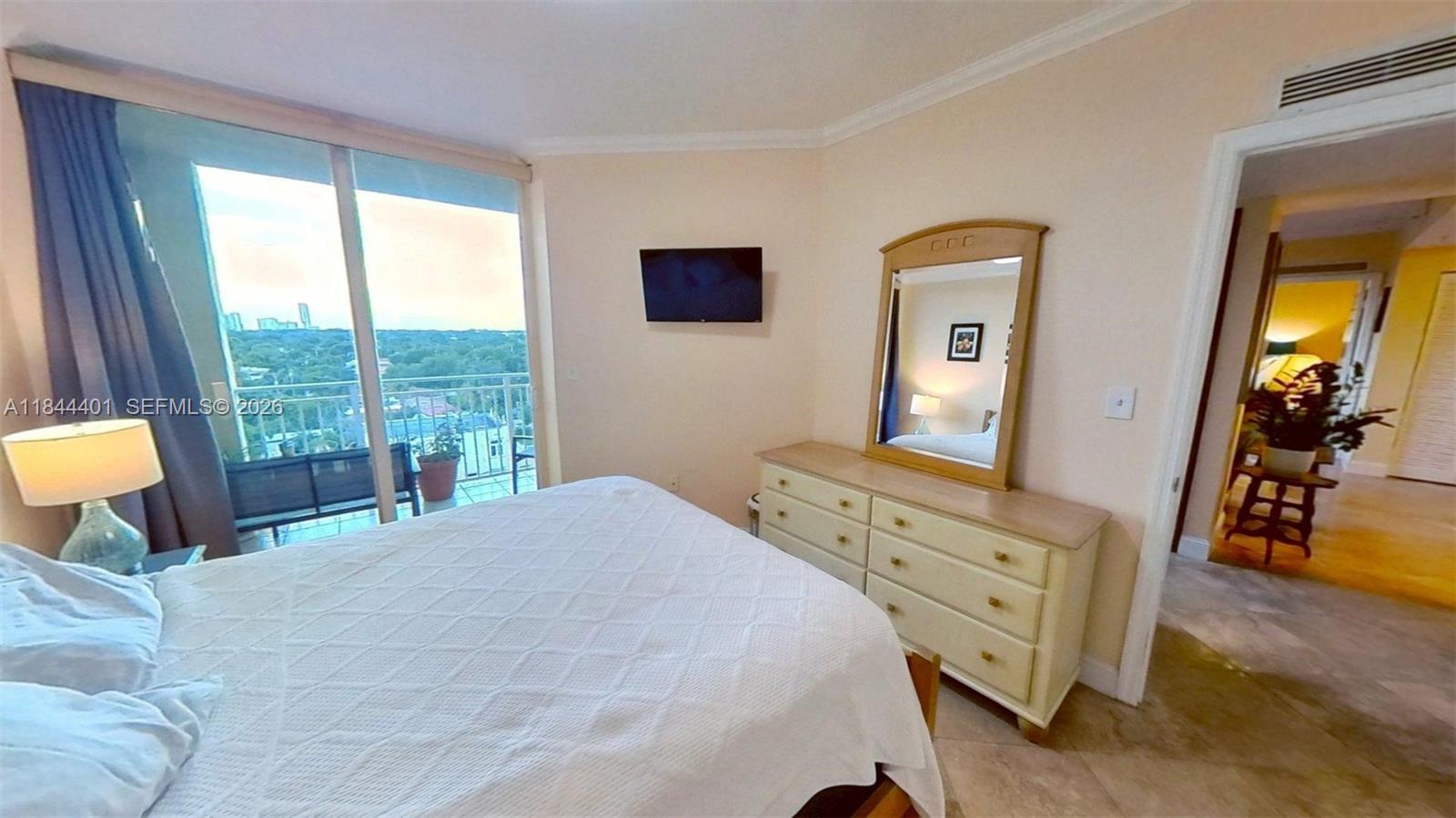 2425 Southwest 27th Avenue, Unit 701 Miami, FL 33145 - Photo 38 of 49 a bedroom with a bed and wooden floor