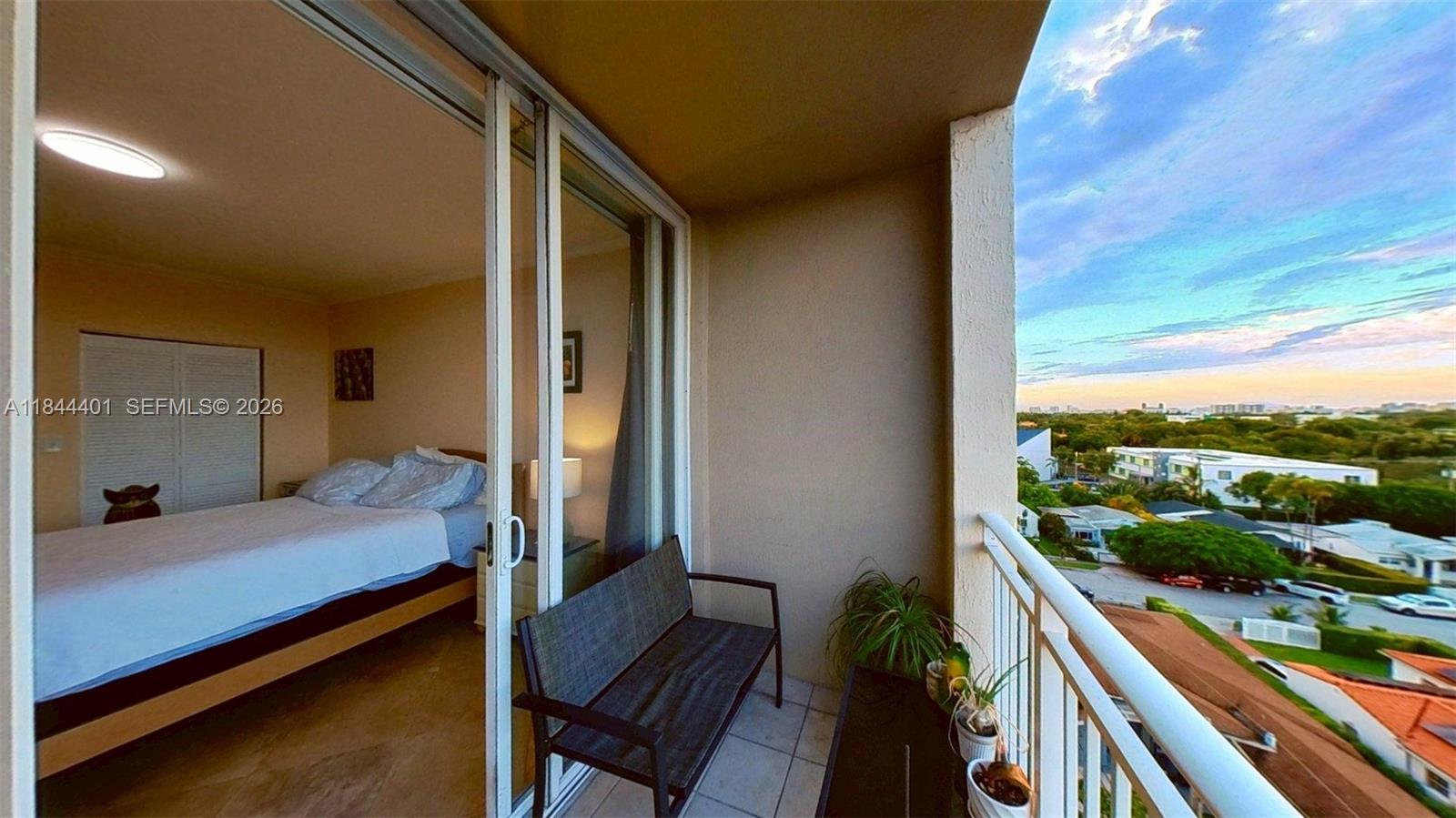 2425 Southwest 27th Avenue, Unit 701 Miami, FL 33145 - Photo 40 of 49 a view of a balcony with chair and wooden floor