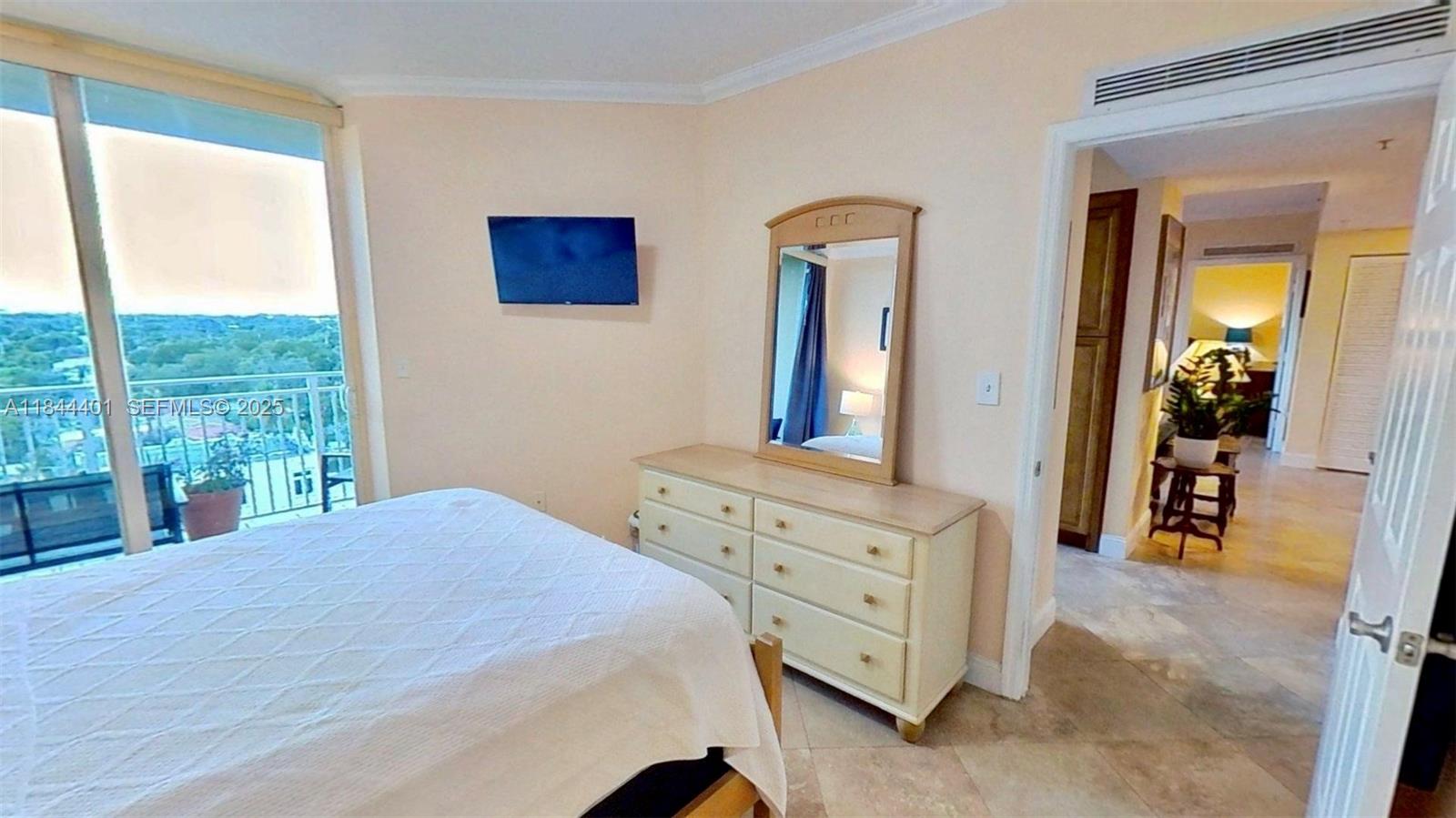 2425 Southwest 27th Avenue, Unit 701 Miami, FL 33145 - Photo 44 of 57 a bedroom with a bed and a dresser