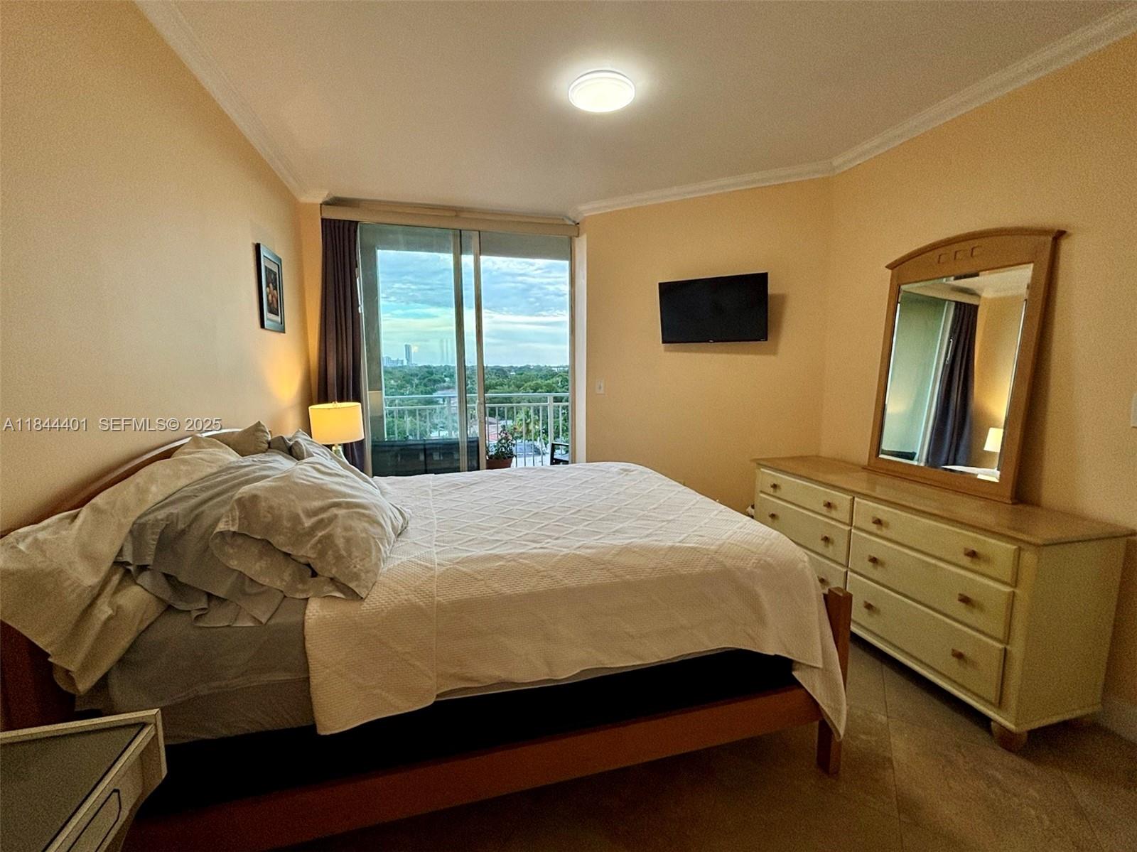 2425 Southwest 27th Avenue, Unit 701 Miami, FL 33145 - Photo 45 of 57 a bed sitting in a bedroom next to a window