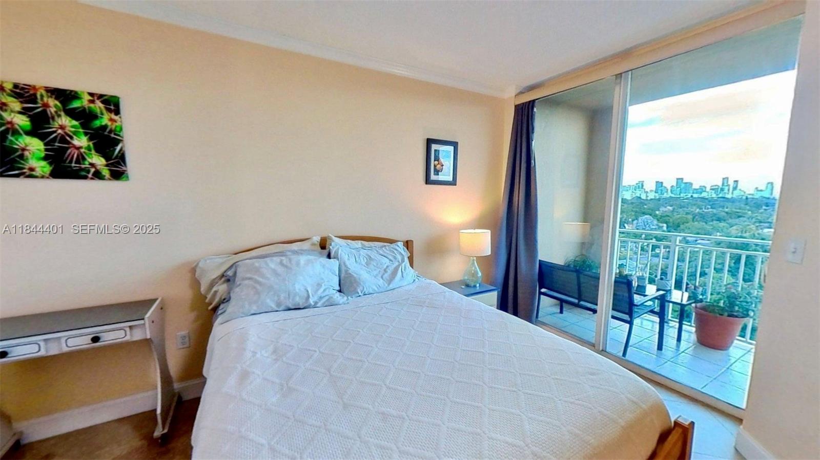 2425 Southwest 27th Avenue, Unit 701 Miami, FL 33145 - Photo 52 of 57 a bedroom with a bed and a window