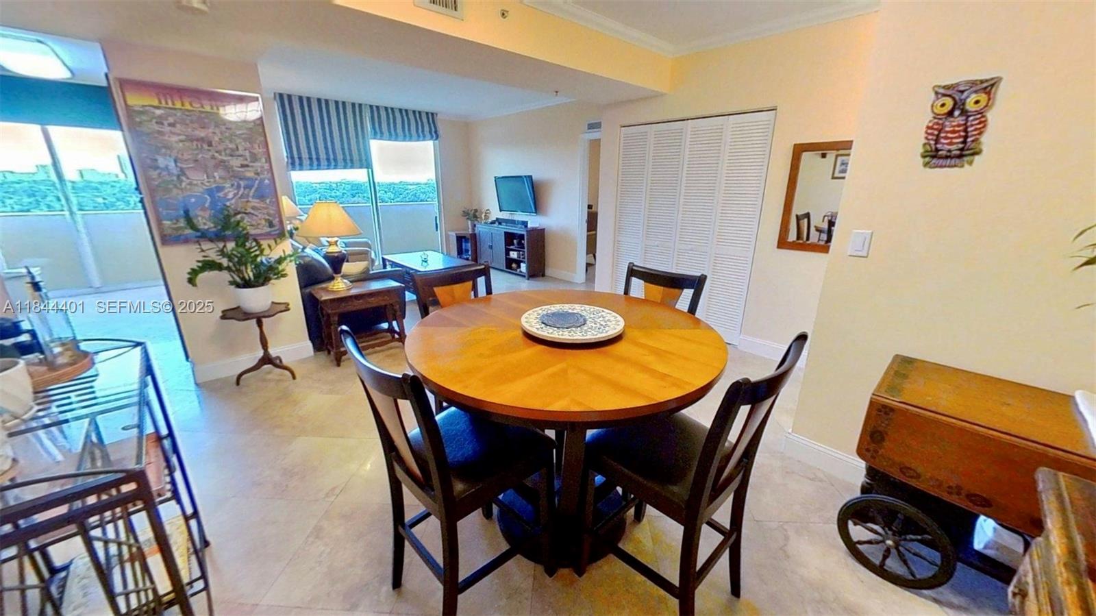2425 Southwest 27th Avenue, Unit 701 Miami, FL 33145 - Photo 8 of 57 a dining room with furniture and a window