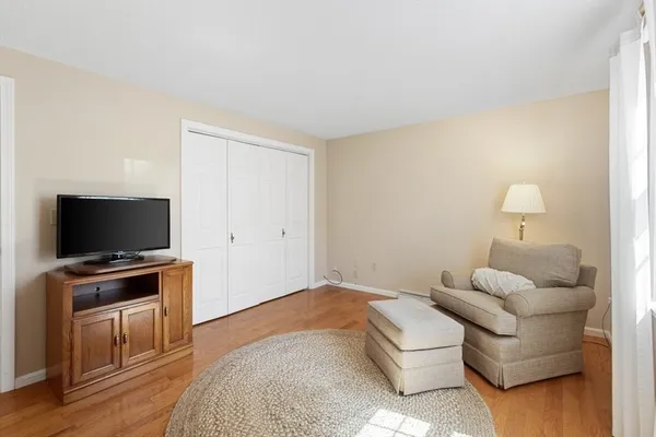a bedroom with furniture and a flat screen tv