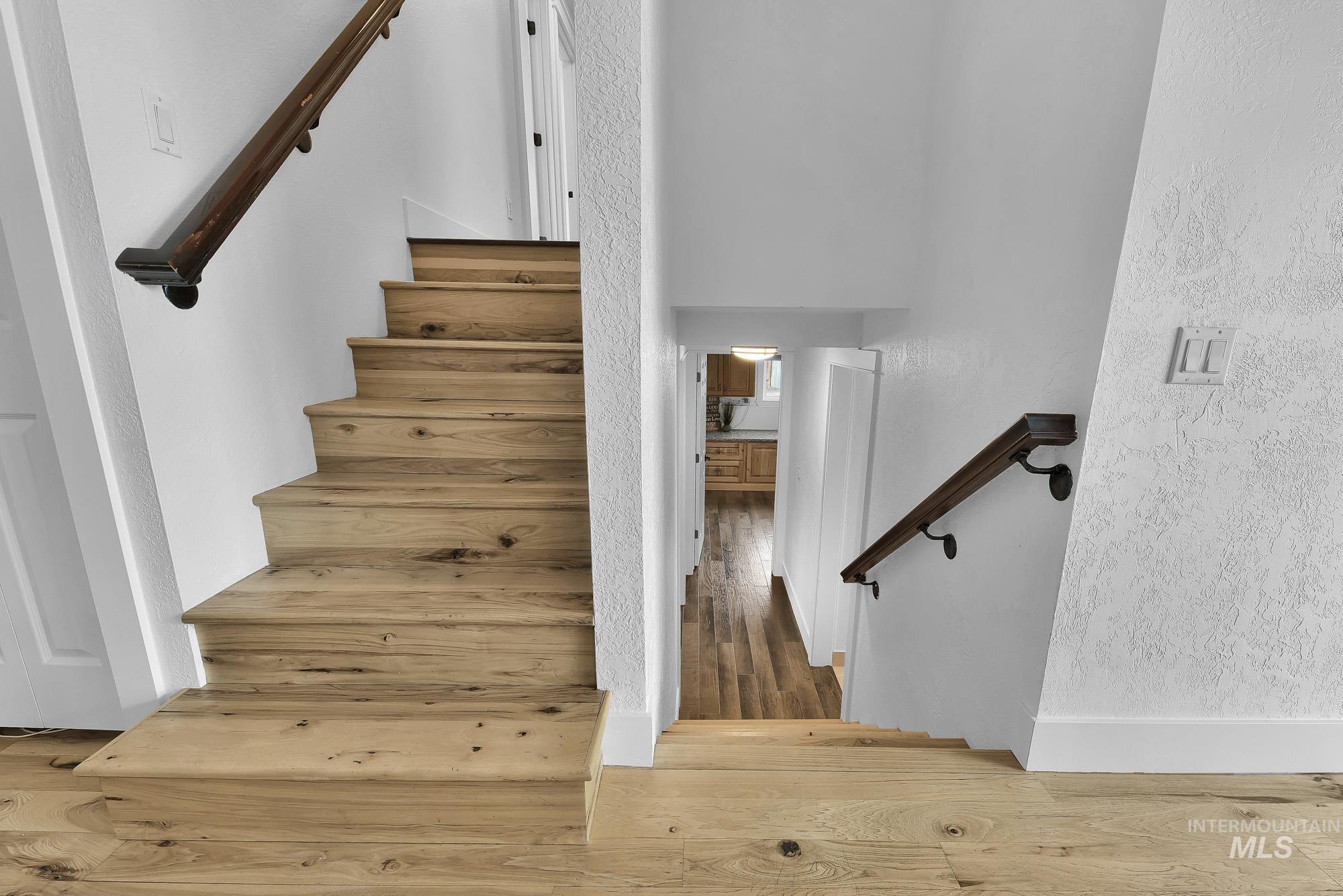 3630 Beverly Street Boise, ID 83709 - Photo 16 of 50 Staircase featuring wood-type flooring and a textured wall