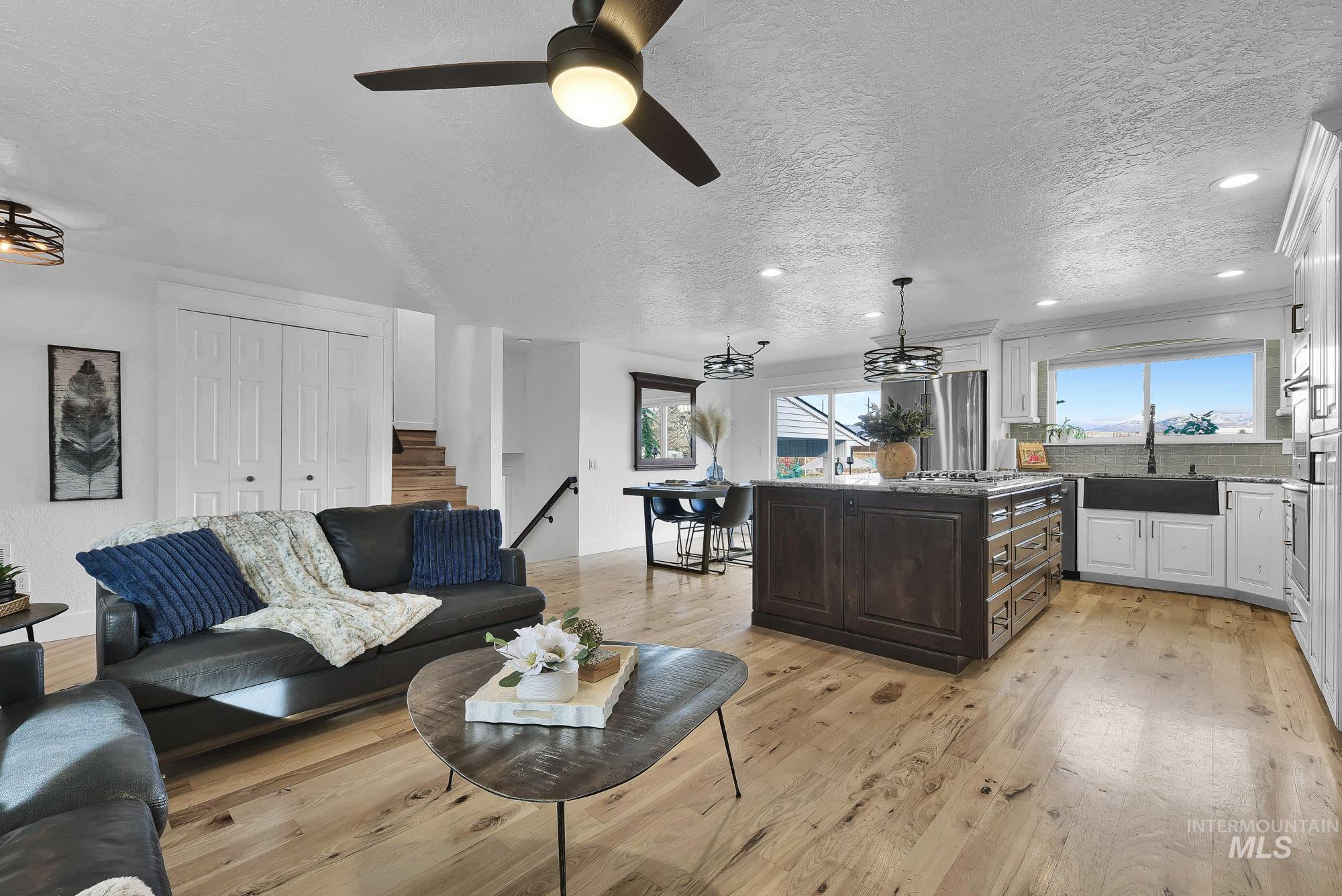 3630 Beverly Street Boise, ID 83709 - Photo 2 of 50 Living room with a textured ceiling, recessed lighting, light wood finished floors, ceiling fan, and stairs