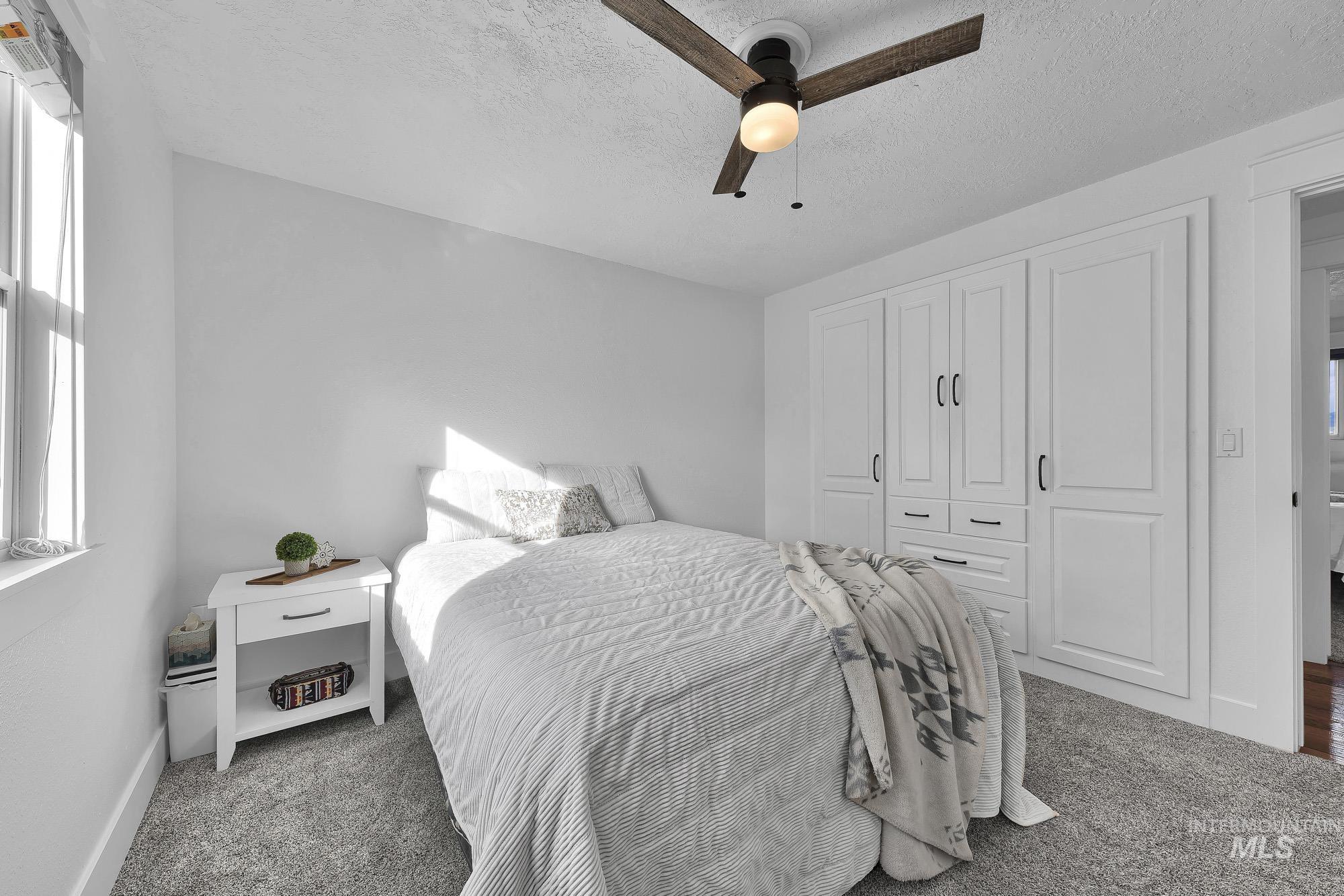 3630 Beverly Street Boise, ID 83709 - Photo 22 of 50 Bedroom featuring a closet, a textured ceiling, carpet, and a ceiling fan
