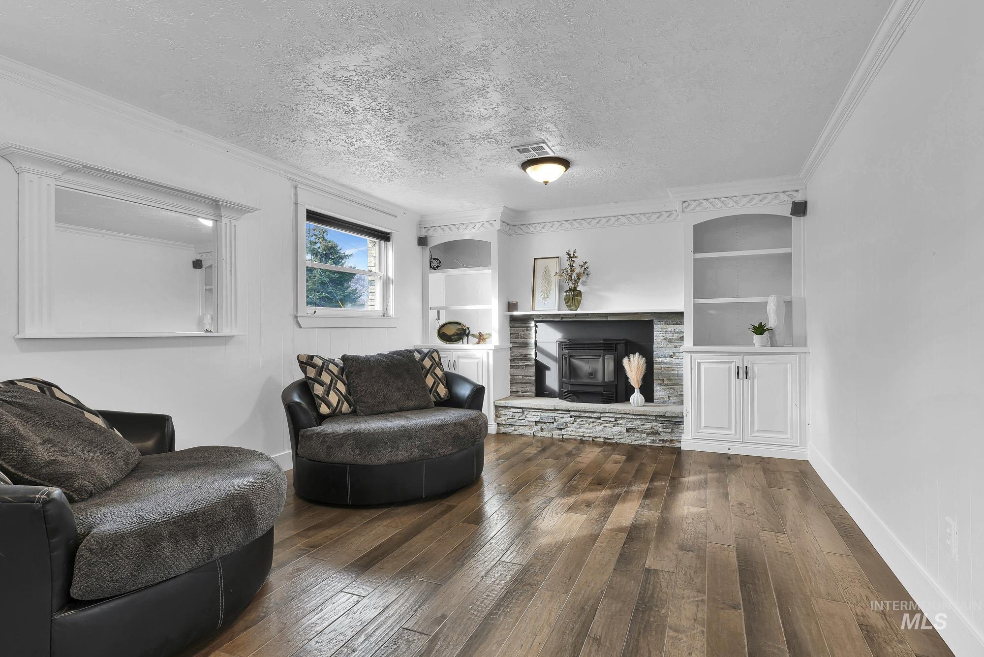 3630 Beverly Street Boise, ID 83709 - Photo 24 of 50 Living area featuring built in features, a textured ceiling, dark wood finished floors, and ornamental molding