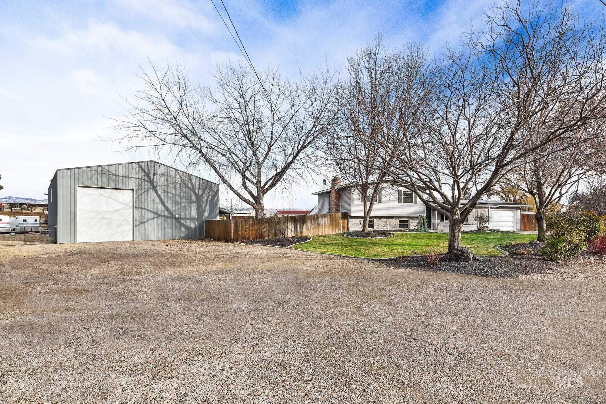 3630 Beverly Street Boise, ID 83709 - Photo 30 of 50 View of property exterior with a detached garage, an outbuilding, and driveway