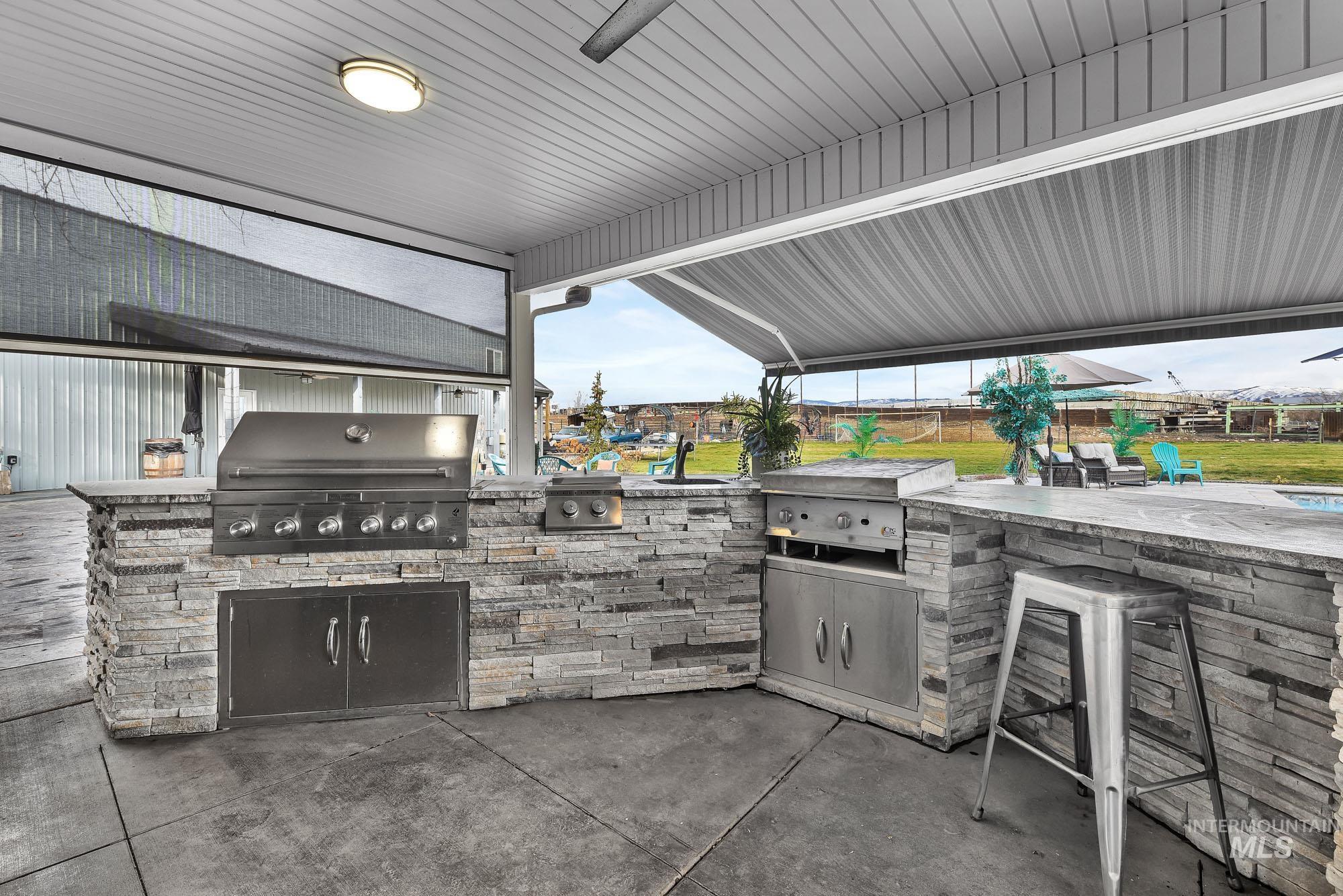 3630 Beverly Street Boise, ID 83709 - Photo 4 of 50 View of patio / terrace featuring area for grilling, an outdoor bar, and a ceiling fan