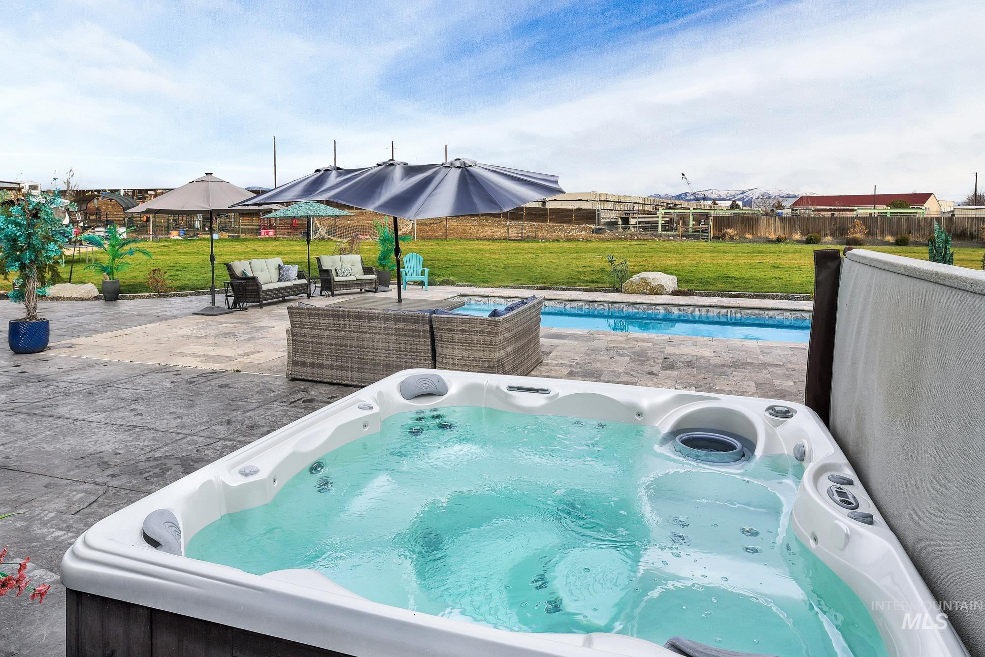 3630 Beverly Street Boise, ID 83709 - Photo 41 of 50 View of swimming pool featuring a fenced backyard, a hot tub, a patio, and an outdoor hangout area