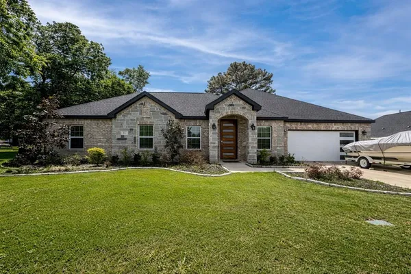a front view of a house with a yard and garage