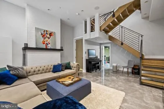 a living room with furniture and a dining table