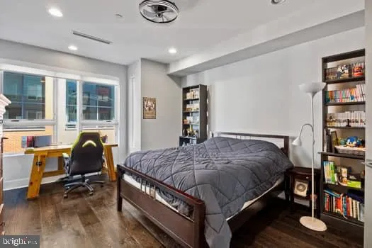 a bedroom with a bed and a chair