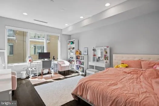 a bedroom with a large bed and a large window