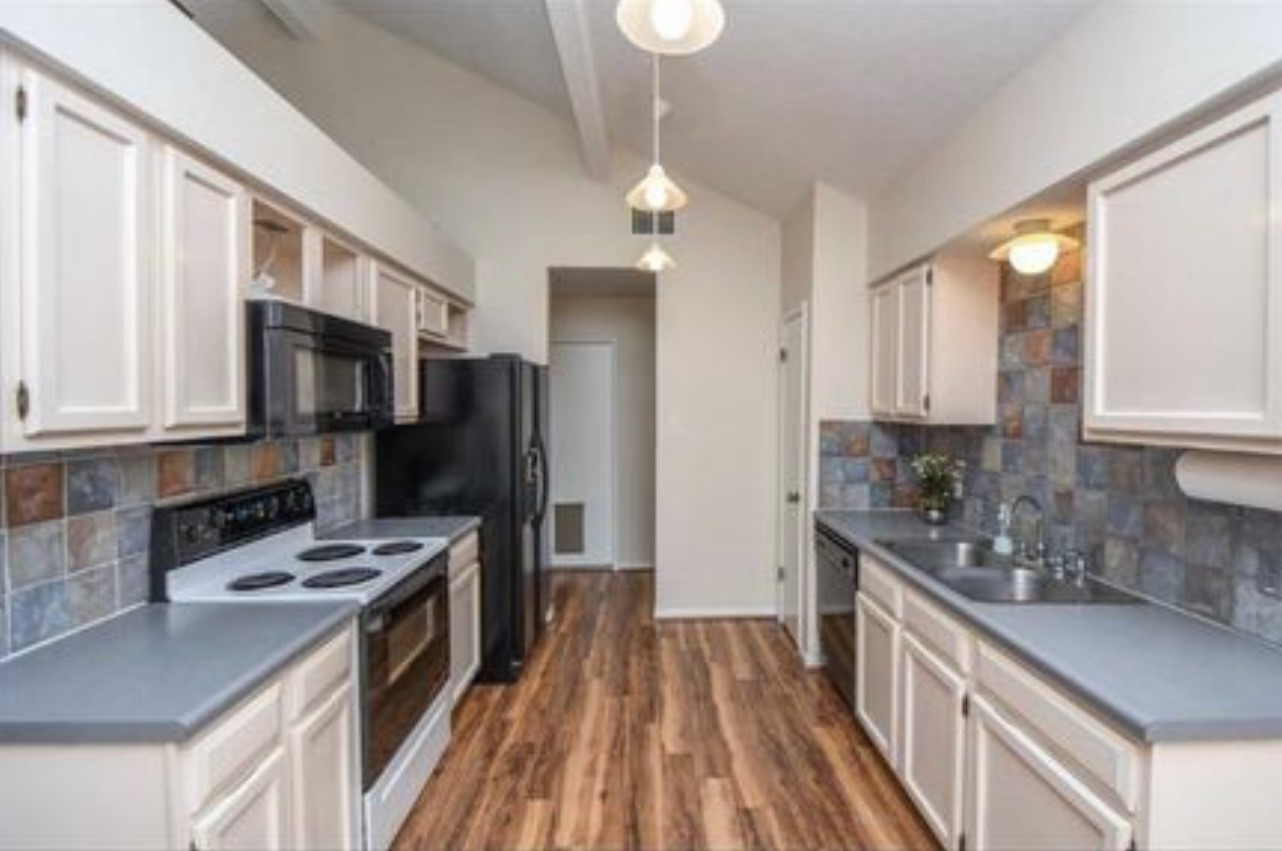 5906 Flower Gate Drive Spring, TX 77373 - Photo 3 of 7 a kitchen with stainless steel appliances a stove sink microwave and refrigerator