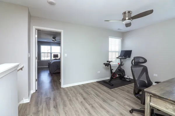 a view of a workspace with furniture and a window