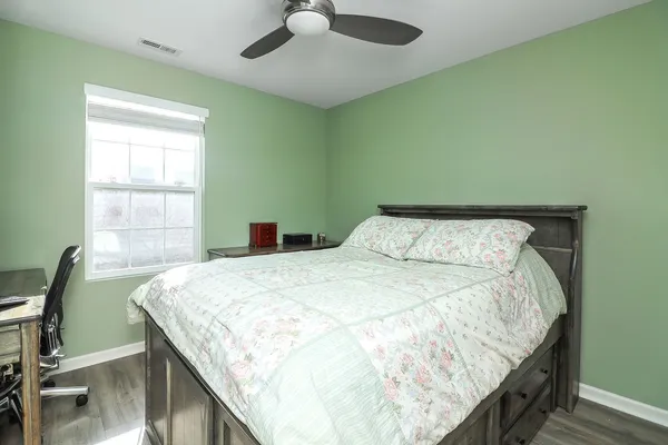 a bed sitting in a bedroom next to a window