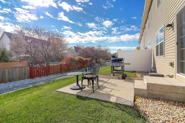 a view of a backyard with sitting area