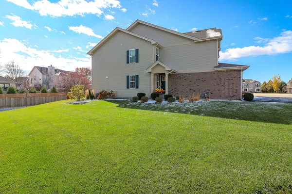 a view of an house with backyard space and garden