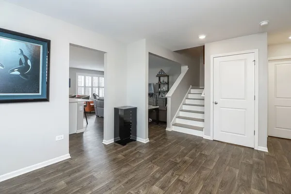 a view of a hallway with wooden floor and entryway
