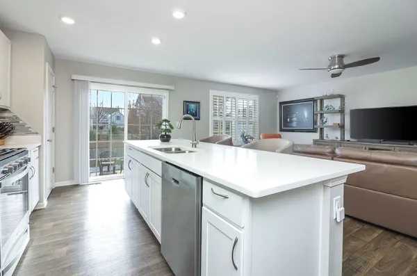 a kitchen with sink stove and refrigerator